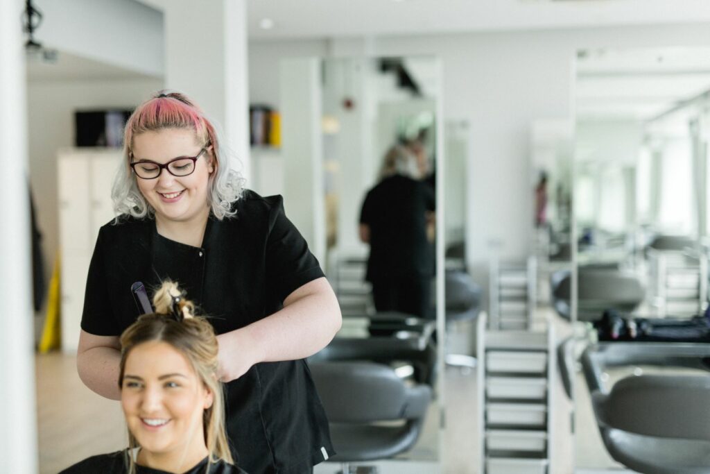 A student cutting hair