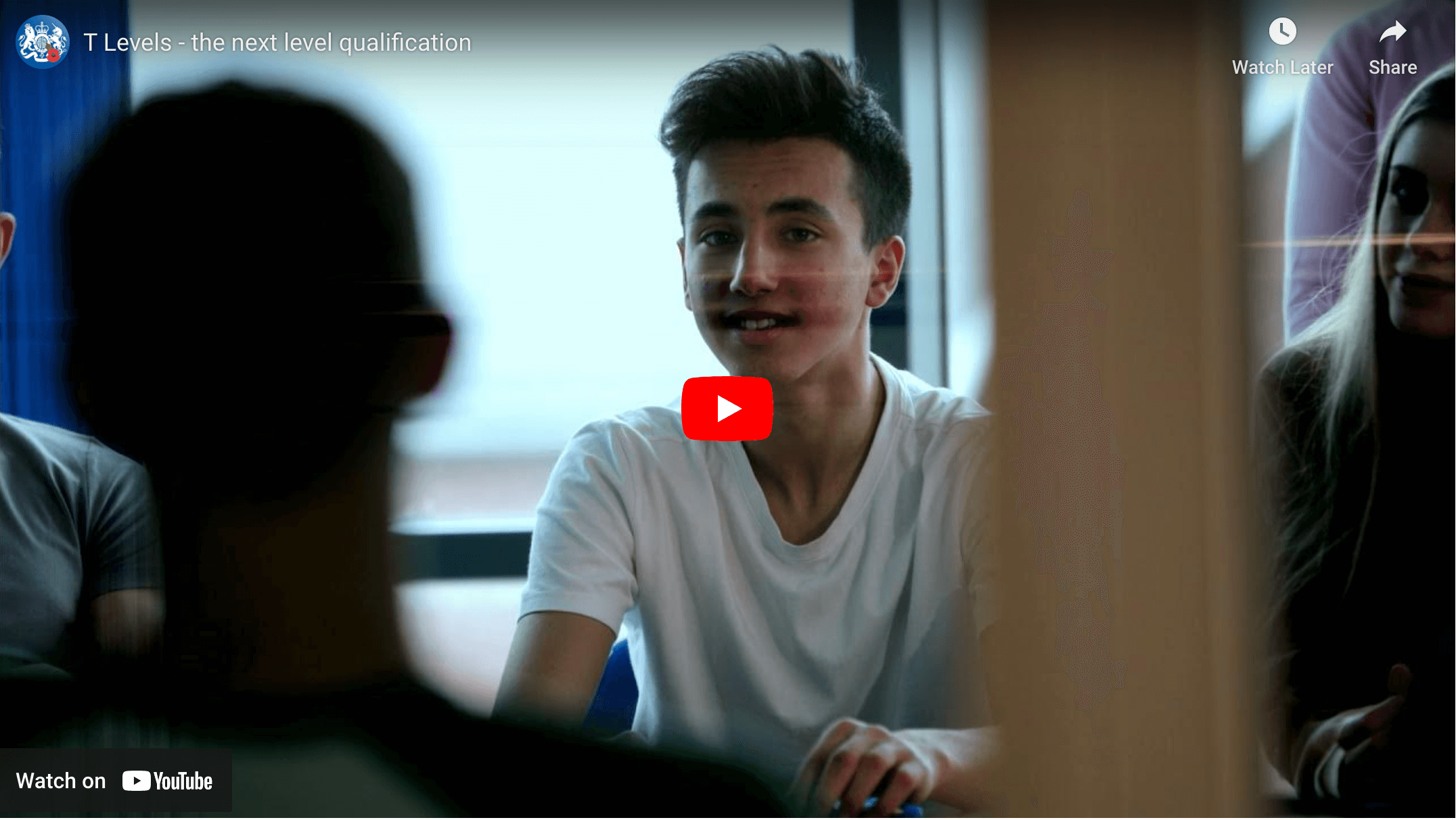 Image of a boy smiling and a red Play button to visit the YouTube video about T Levels