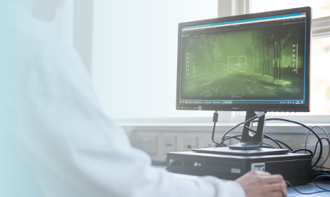 Desktop computer with an arm and hand showing controlling the mouse, with a blue gradient overlay on the left side of the image